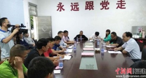 2019 年“七一”前夕，福安市长钟宜国到大车村开展党日活动。图为陈振平向钟市长汇报工作。